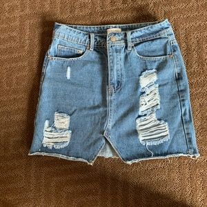 Distressed denim skirt.